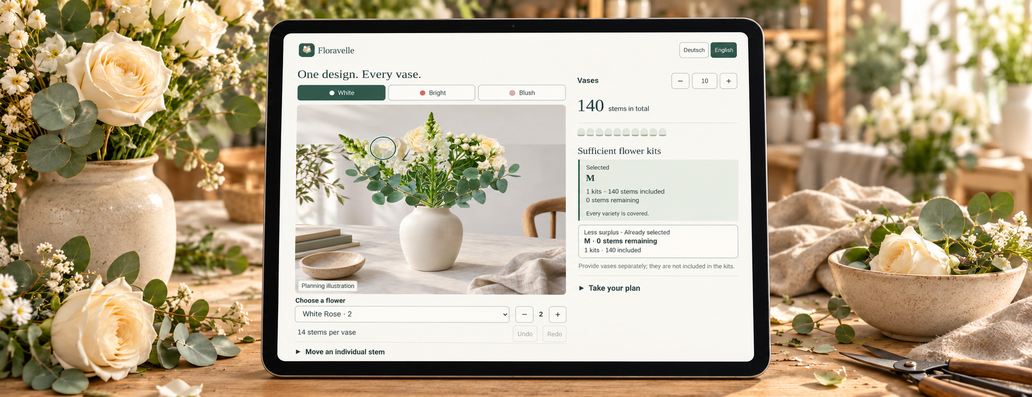 Floravelle floral designer on a tablet among flowers and vases